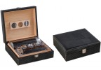 Two humidors with black alligator pattern one is open showing a leather cigar humi-tube and a leather cigar case the other one is closed