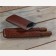 Two brown leather cigar case on has two cigars the other one is empty