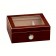 A small and elegant glass humidor  in cherry finish with see through glass on top and an external hygrometer