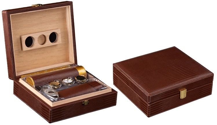 Two humidors with brown alligator pattern one is open showing a leather cigar humi-tube and a leather cigar case the other one is closed