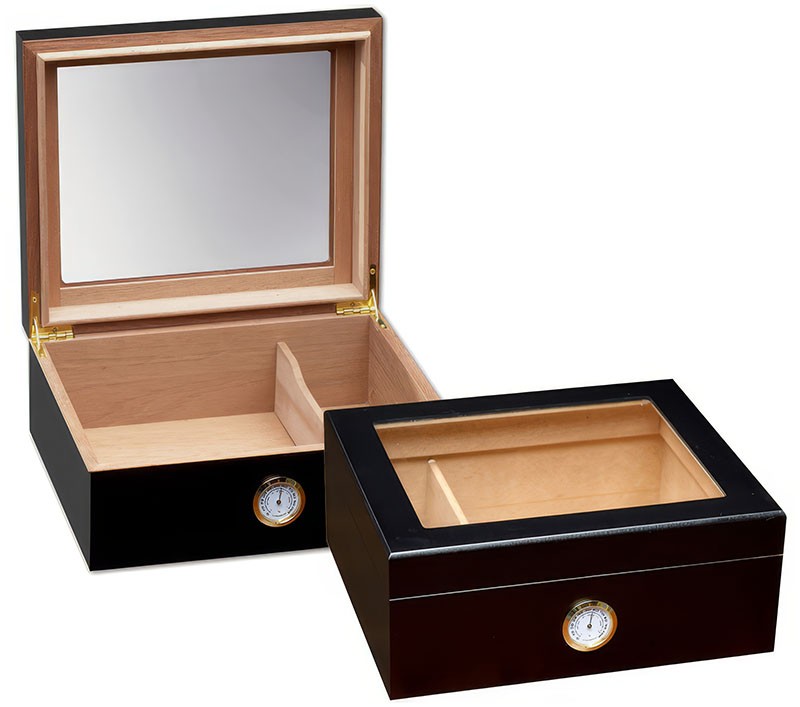 Two small and elegant glass humidors in black with see through glass on top and an external hygrometer, one humidor is closed and the other one is open