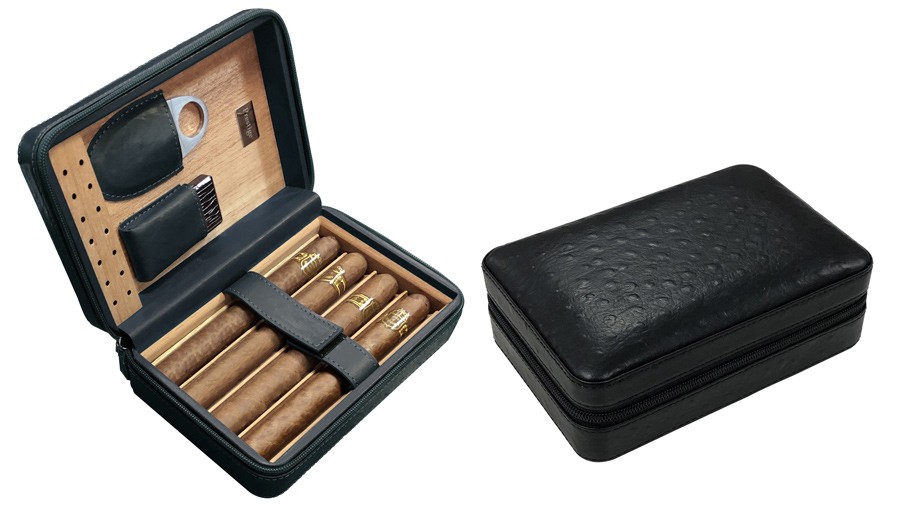 Two travel humidors in black leather one is open showing four cigars, a guillotine cigar cutter and a flip-top lighter the other is closed