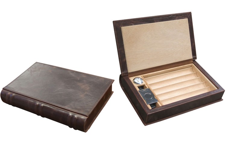 Two leather book-like humidors one is closed the other one is open showing a hygrometer, humidifier and guillotine cutter