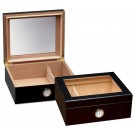Two small and elegant glass humidors in black with see through glass on top and an external hygrometer, one humidor is closed and the other one is open