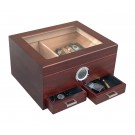 Glass top humidor in cherry finish with an external hygrometer and two drawers open showing accessories inside