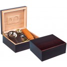 Two cherry wood humidors one is open showing a hygrometer, a double blade guillotine cutter, and a leather cigar case the other one is closed